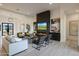 Elegant living room with a modern fireplace, mounted TV, and stylish furniture at 1940 E Creek Canyon Rd, Phoenix, AZ 85086