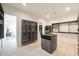 Custom closet with an island and cabinetry, adjacent to a laundry area for added convenience at 1940 E Creek Canyon Rd, Phoenix, AZ 85086