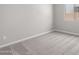 Neutrally decorated bedroom with large window and plush carpet at 23769 N 163Rd Dr, Surprise, AZ 85387