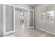 Open bedroom with light wood floors, neutral walls and french doors at 23769 N 163Rd Dr, Surprise, AZ 85387