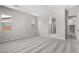Spacious bedroom with neutral walls, carpet, and walk-in bathroom and closet at 23769 N 163Rd Dr, Surprise, AZ 85387