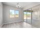 Bright dining room features modern chandelier, light wood floors and sliding glass doors to backyard at 23769 N 163Rd Dr, Surprise, AZ 85387