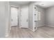 Entryway featuring light wood floors, neutral walls and white doors at 23769 N 163Rd Dr, Surprise, AZ 85387