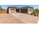 Exterior elevation of home featuring brick driveway and two car garage at 23769 N 163Rd Dr, Surprise, AZ 85387