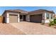 Exterior elevation of home featuring brick driveway and two car garage at 23769 N 163Rd Dr, Surprise, AZ 85387