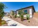 Charming front yard with desert landscaping, young trees, and exterior shutters at 23769 N 163Rd Dr, Surprise, AZ 85387