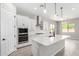 Well-lit kitchen with white cabinets, stainless steel appliances, and a spacious center island at 23769 N 163Rd Dr, Surprise, AZ 85387