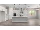 Bright, open kitchen with white cabinets, stainless steel appliances, and a large center island at 23769 N 163Rd Dr, Surprise, AZ 85387