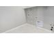 Clean and bright laundry room with tile flooring, hookups, and overhead shelving at 23769 N 163Rd Dr, Surprise, AZ 85387