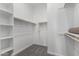 Spacious walk-in closet with built in shelving and wood closet rods at 23769 N 163Rd Dr, Surprise, AZ 85387