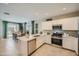 Well-equipped kitchen with stainless steel appliances, white cabinets, and a view of the adjacent dining area at 24886 N 167Th Dr, Surprise, AZ 85387