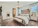 Bright main bedroom featuring a wooden headboard, neutral decor and comfortable carpeting at 24886 N 167Th Dr, Surprise, AZ 85387