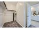 Empty walk-in closet featuring neutral carpet, rod and shelving, providing ample storage space at 24886 N 167Th Dr, Surprise, AZ 85387