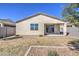 Backyard view features stucco exterior, tiled roof, covered patio with sliding glass door access, and landscaping at 36217 N Urika Dr, San Tan Valley, AZ 85140