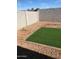 Low-maintenance backyard featuring turf and gravel landscaping, plus a block fence for privacy at 36217 N Urika Dr, San Tan Valley, AZ 85140