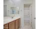 Well-lit bathroom with double sink vanity, framed mirror, and a separate door into the shower at 36217 N Urika Dr, San Tan Valley, AZ 85140