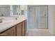 Elegant bathroom featuring double sinks, vanity, and a modern glass shower at 36217 N Urika Dr, San Tan Valley, AZ 85140