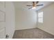 Bright bedroom featuring neutral carpet, ceiling fan, and window with light blocking blinds at 36217 N Urika Dr, San Tan Valley, AZ 85140