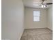 Cozy bedroom with neutral carpet, ceiling fan, and a window with bright natural light at 36217 N Urika Dr, San Tan Valley, AZ 85140