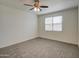 Bright bedroom with neutral carpet, ceiling fan, and a window with blinds at 36217 N Urika Dr, San Tan Valley, AZ 85140