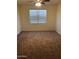 A carpeted bedroom with a large window and ceiling fan is freshly painted at 36217 N Urika Dr, San Tan Valley, AZ 85140