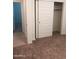 A carpeted bedroom featuring an open closet with sliding doors and neutral-colored walls at 36217 N Urika Dr, San Tan Valley, AZ 85140