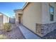 Exterior view of single story home and gravel landscaped side yard at 36217 N Urika Dr, San Tan Valley, AZ 85140