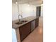 Kitchen island featuring granite countertops, stainless steel appliances, undermount sink with stainless faucet, and custom cabinetry at 36217 N Urika Dr, San Tan Valley, AZ 85140