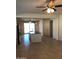 Bright and airy living room featuring tile floors, neutral walls, a ceiling fan, and access to the outdoors at 36217 N Urika Dr, San Tan Valley, AZ 85140