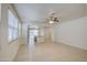 Open-concept living space featuring tile flooring, ceiling fan, and seamless flow to the kitchen at 36217 N Urika Dr, San Tan Valley, AZ 85140