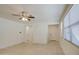 Inviting living area with tile flooring, ceiling fan, and access to multiple rooms at 36217 N Urika Dr, San Tan Valley, AZ 85140