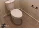 A white toilet is featured in this bathroom with neutral-colored tile floors and walls at 36217 N Urika Dr, San Tan Valley, AZ 85140