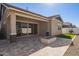 Beautiful covered patio and backyard featuring a gas firepit and well-manicured yard at 4156 E Bernice St, Gilbert, AZ 85295