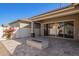 Backyard featuring a stone gas firepit, covered patio, and colorful vines on the privacy wall at 4156 E Bernice St, Gilbert, AZ 85295