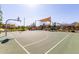 Outdoor basketball court with a green surface, white lines, and surrounding landscaping in a residential area at 4156 E Bernice St, Gilbert, AZ 85295