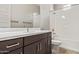 Bathroom featuring a dark vanity, shower and tub combination, and white color scheme at 4156 E Bernice St, Gilbert, AZ 85295