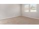 An empty bedroom featuring neutral carpet, a window with blinds, and fresh paint at 4156 E Bernice St, Gilbert, AZ 85295