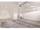 Clean two car garage with concrete floor, white walls, and storage space at 4156 E Bernice St, Gilbert, AZ 85295