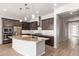 Modern kitchen with stainless steel appliances, a large island, pendant lighting and stylish backsplash at 4156 E Bernice St, Gilbert, AZ 85295