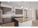 Contemporary kitchen featuring a large island with a sink, stainless steel appliances, and elegant lighting at 4156 E Bernice St, Gilbert, AZ 85295