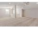 Spacious loft area with neutral carpet, ceiling fan, and abundant natural light at 4156 E Bernice St, Gilbert, AZ 85295