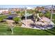 Community park playground with slides and a picnic shelter surrounded by lush greenery at 4156 E Bernice St, Gilbert, AZ 85295