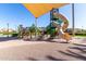 Community playground with a shade structure, climbing structure, slides, and a soft sand and poured-in-place surface at 4156 E Bernice St, Gilbert, AZ 85295