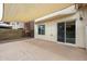 Spacious back patio includes a sliding glass door, large windows, and a neutral color scheme at 4613 E Douglas Ave, Gilbert, AZ 85234