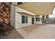 Covered back patio features a neutral color scheme, large windows, and access to the yard at 4613 E Douglas Ave, Gilbert, AZ 85234