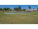 This park has a basketball court surrounded by mature trees and lush green grass at 4613 E Douglas Ave, Gilbert, AZ 85234