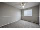 Bedroom features neutral paint, carpet, ceiling fan and one window to let in natural light at 4613 E Douglas Ave, Gilbert, AZ 85234