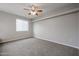 Bedroom features neutral paint, carpet and a ceiling fan at 4613 E Douglas Ave, Gilbert, AZ 85234