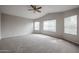 Bedroom with carpet, ceiling fan, and large windows at 4613 E Douglas Ave, Gilbert, AZ 85234