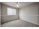 Neutral bedroom with carpet, ceiling fan, window and base trim throughout the room at 4613 E Douglas Ave, Gilbert, AZ 85234